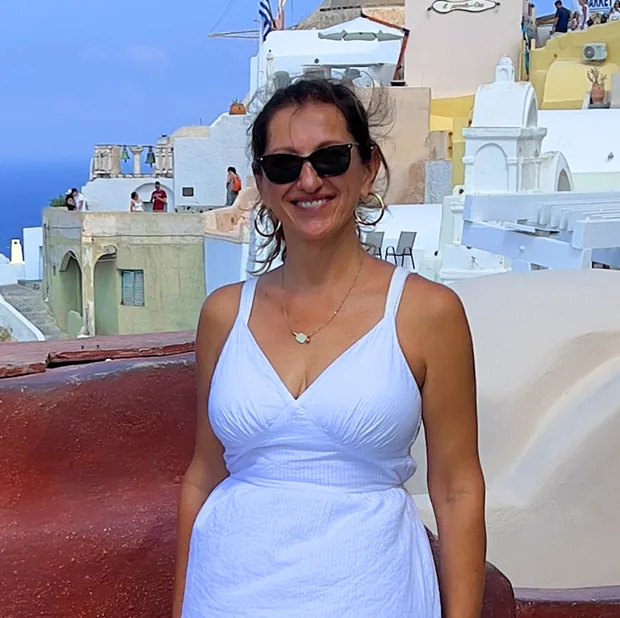 Vesna Telalovic in Oia, Santorini, among whitewashed cliffside buildings